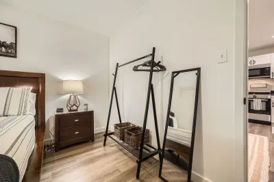 Stylish bedroom with full-length mirrors and warm lighting.