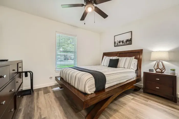Comfortable bedroom with hardwood floors and a peaceful vibe.