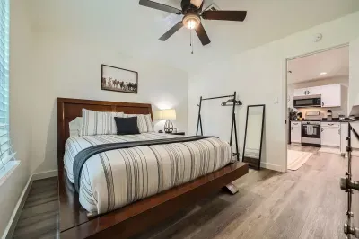 Spacious bedroom with clean lines and hardwood floors.