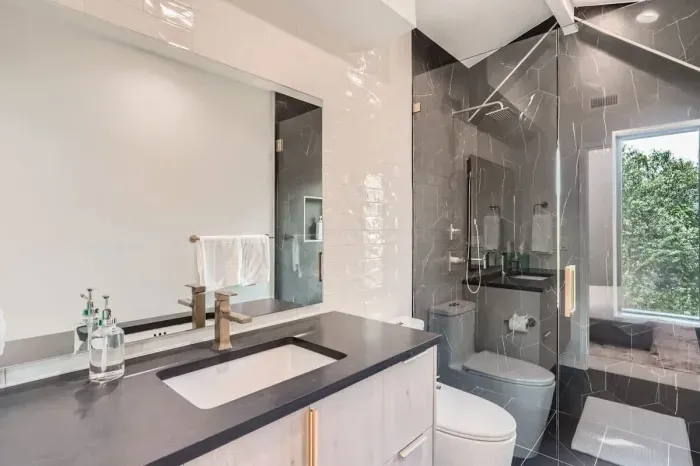 Modern bathroom with sleek fixtures, a spacious shower, and high-end amenities.