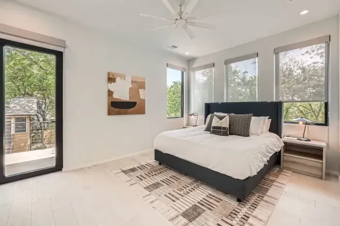 Sleep like royalty in this spacious primary bedroom with a king-size bed and chic, contemporary decor.