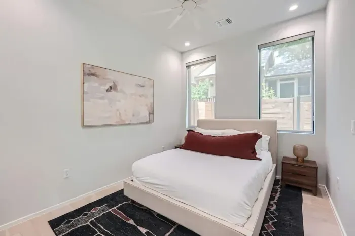 A stylish queen-size bed, smart lighting, and a cozy ambiance make this room the perfect spot to relax after a day of exploring.