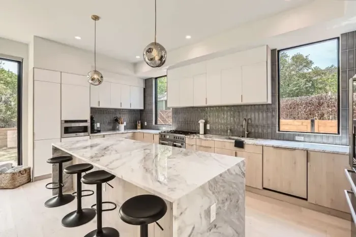 2. Spacious kitchen with a large island and seating, ideal for enjoying morning coffee or group meal prep.