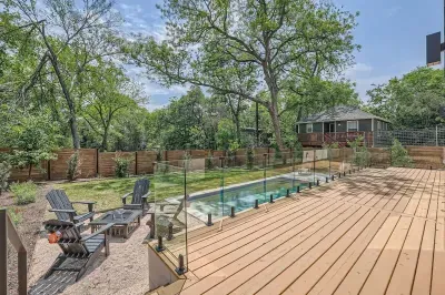 3. Private backyard oasis featuring a large deck, comfy seating, and a fire pit for cozy evenings.