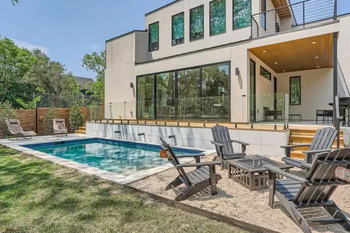 1. Gorgeous backyard with a sparkling pool, perfect for sunbathing and swimming.