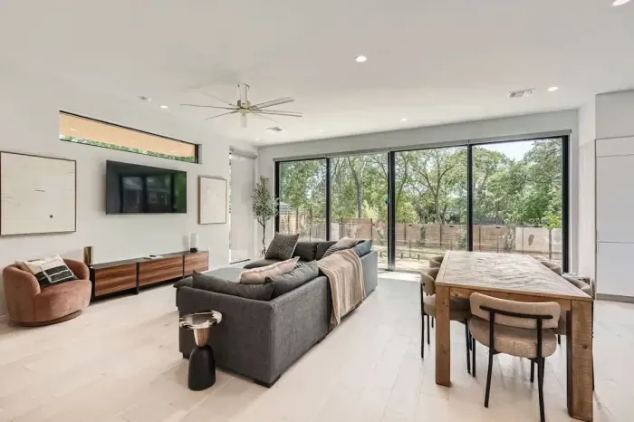 Spacious and bright living room with large windows and serene views.