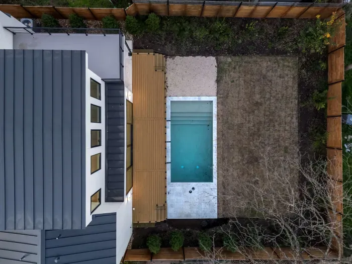 Escape the hustle and bustle in our backyard paradise, where the pool beckons you to relax.