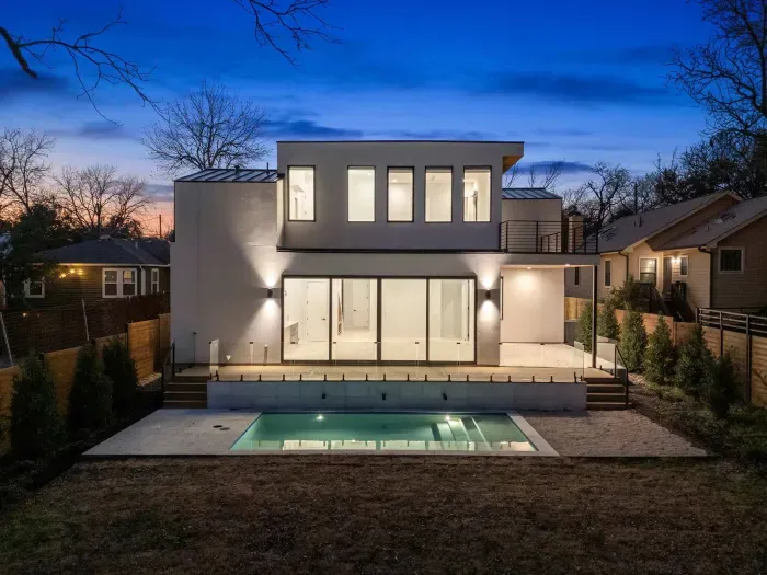 Modern home with sleek lines, large windows, and a minimalist design.