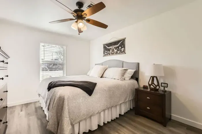 Peaceful bedroom with a plush queen-sized bed and soft linens for a restful night’s sleep.