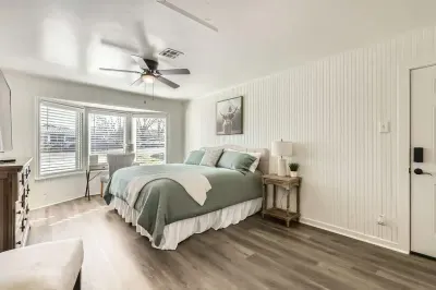 Sleep like royalty in this spacious primary bedroom with a king-size bed and chic, contemporary decor.