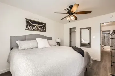 Romantic bedroom with elegant lighting and soft, neutral tones.