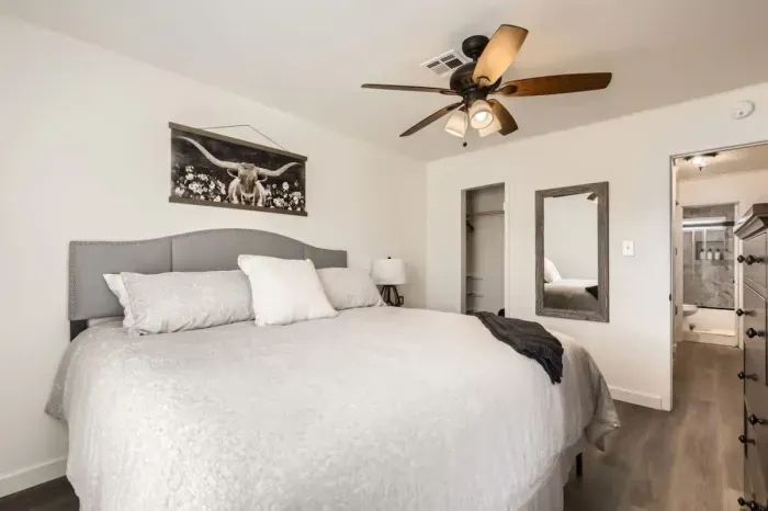 Romantic bedroom with elegant lighting and soft, neutral tones.
