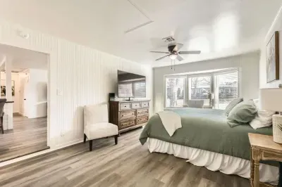 Sleep like royalty in this spacious primary bedroom with a king-size bed and chic, contemporary decor.