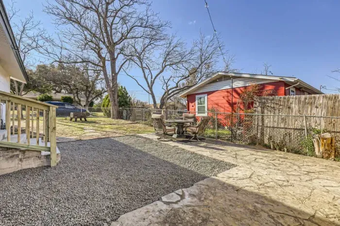 Well-maintained backyard with a variety of trees and shrubs for a natural, private setting.