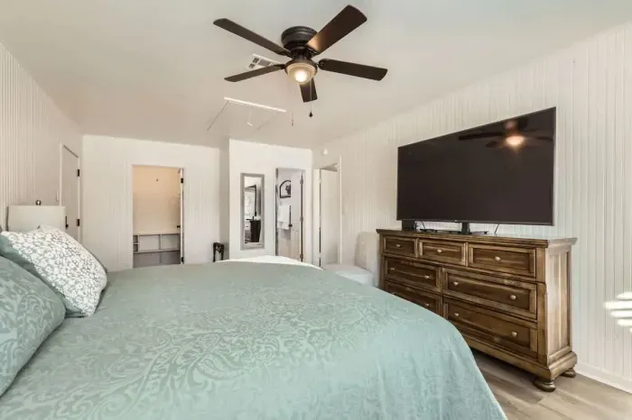 Sleep like royalty in this spacious primary bedroom with a king-size bed and chic, contemporary decor.