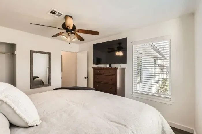 Peaceful bedroom with a plush queen-sized bed and soft linens for a restful night’s sleep.