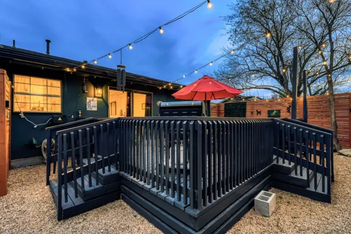 Elevated private deck with string lights and seating, creating a relaxed outdoor space for evenings and gatherings
