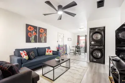 Open-concept living area with in-unit washer and dryer, connecting seamlessly to dining and backyard access