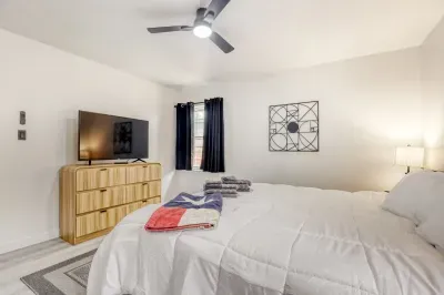 Inviting primary bedroom with ample space, cozy bedding, and convenient access to closet and essentials