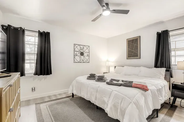 Bright and relaxing bedroom with blackout curtains, fresh linens, and thoughtful touches for a restful night