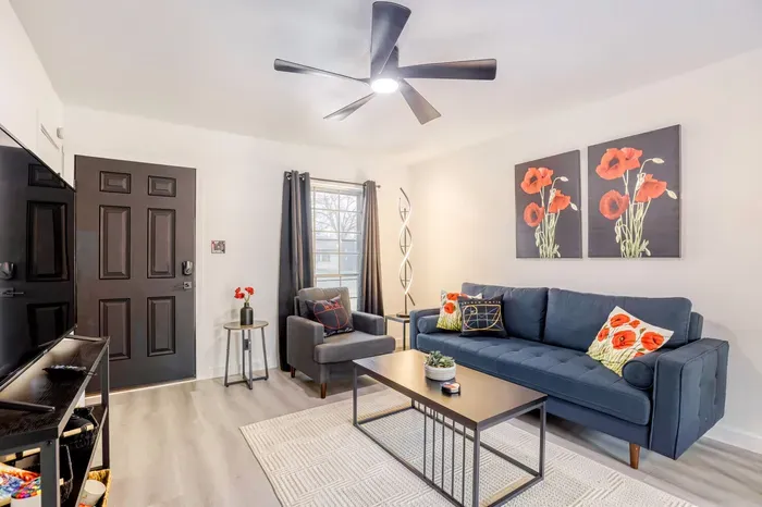 Bright, modern living room with comfortable seating, smart TV, and a clean, relaxed layout for easy downtime