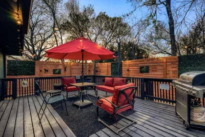 Spacious backyard deck with grill and dining setup, designed for easy nights in with friends or family