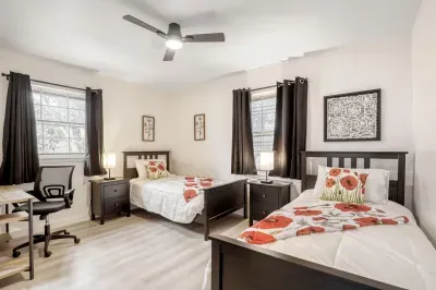 Spacious bedroom with two twin beds, perfect for kids, friends, or flexible group sleeping