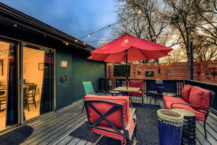 Private deck with string lights, grill, and cozy seating, perfect for relaxing evenings under the Texas sky