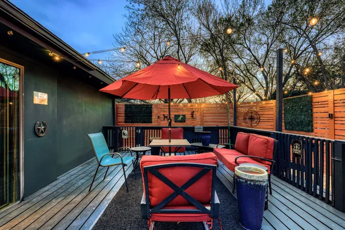 Backyard retreat with grill, string lights, and relaxed seating, perfect for enjoying warm Central Texas nights