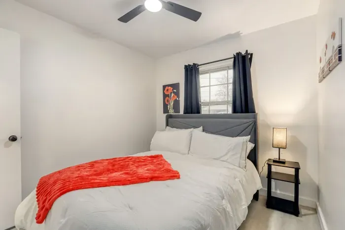 Comfortable bedroom with plush bedding, soft lighting, and a simple layout designed for restful nights