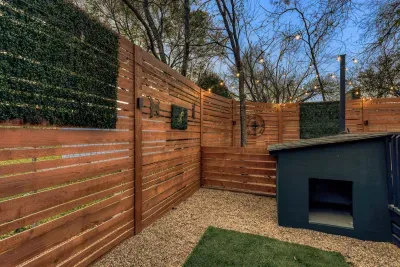Pet-friendly backyard with a dedicated dog house and secure fenced space for your pup to relax and roam