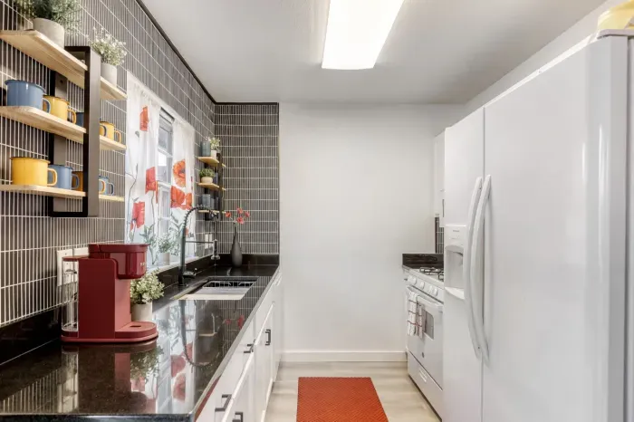 Clean, fully equipped kitchen with sleek finishes and a simple layout that makes cooking feel effortless
