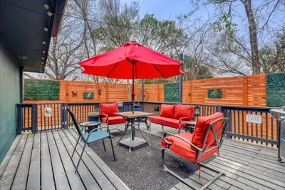 Private backyard patio with shaded seating and outdoor dining, perfect for relaxing evenings or morning coffee