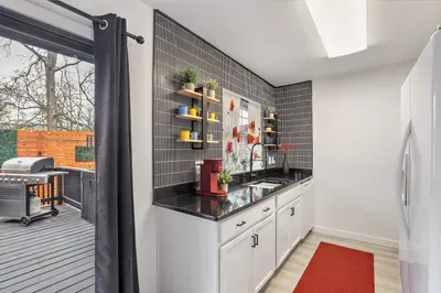 Modern kitchen with coffee station and direct access to the private patio and grill for easy indoor-outdoor living