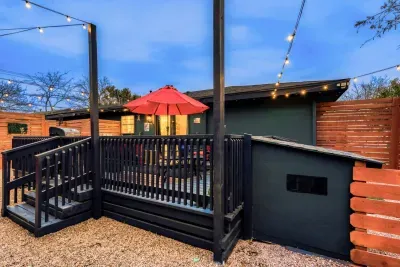 Fully fenced backyard with cozy dog house and deck access, designed for both you and your pup to enjoy