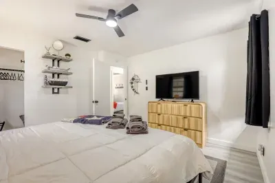 Comfortable primary suite with smart TV, dresser storage, and a layout designed for longer, easy stays