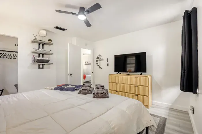 Comfortable primary suite with smart TV, dresser storage, and a layout designed for longer, easy stays