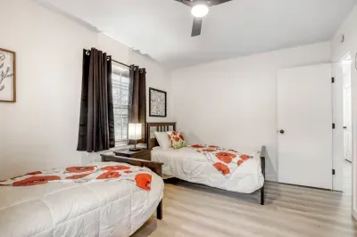 Dual twin bedroom with natural light, comfortable bedding, and a simple setup for shared stays