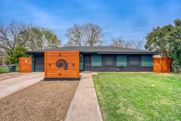 Front exterior with bold wood accents, private drive, and clean modern curb appeal just minutes from Georgetown Square