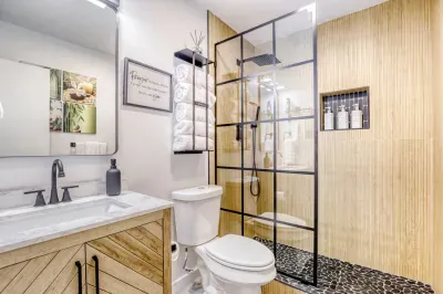 Modern bathroom with walk-in glass shower, rainfall head, and clean finishes for a spa-like start or end to your day