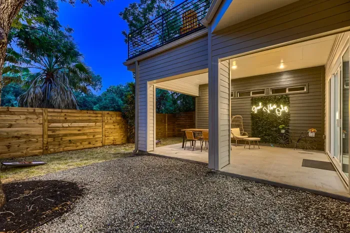 Spacious backyard with a covered patio area for dining, lounging, or entertaining.