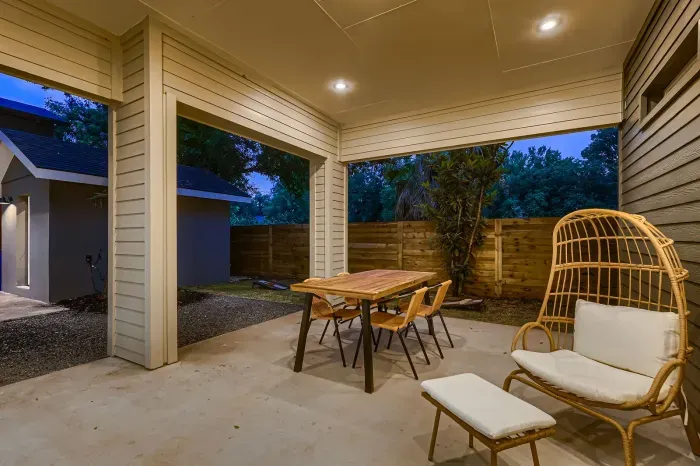 Backyard offering shade and comfort for outdoor dining or lounging.