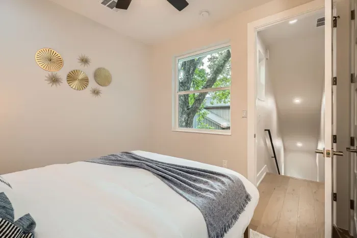 A serene space with soft, neutral tones and a plush queen bed; perfect for unwinding after a busy day.