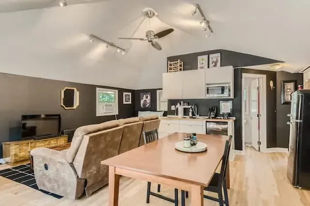 Bright and airy dining area with large windows and cozy seating for memorable meals.