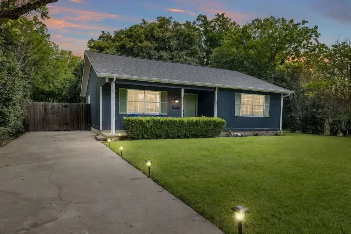 Charming exterior with a welcoming front porch and beautifully landscaped yard.