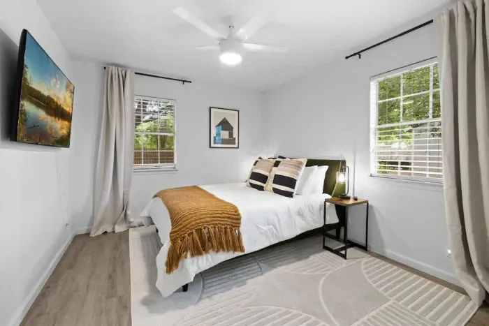 Peaceful bedroom with a plush queen-sized bed and soft linens for a restful night’s sleep.