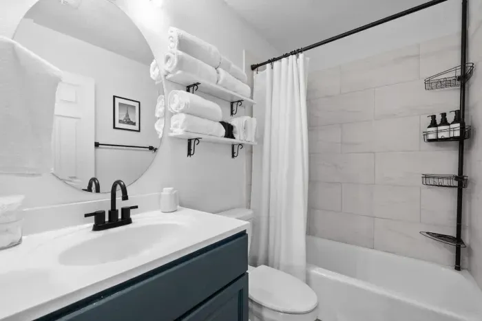 Bright and fresh bathroom with a combination tub and shower, perfect for unwinding.