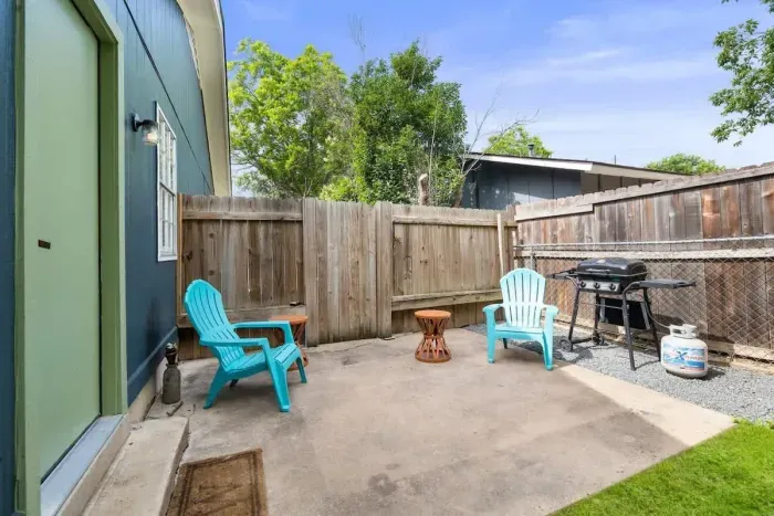 Step outside to the side hangout and grill area, conveniently located off the dining and kitchen. This space is perfect for casual meals, barbecues, and socializing, offering a seamless flow from the indoor to the outdoor living areas.