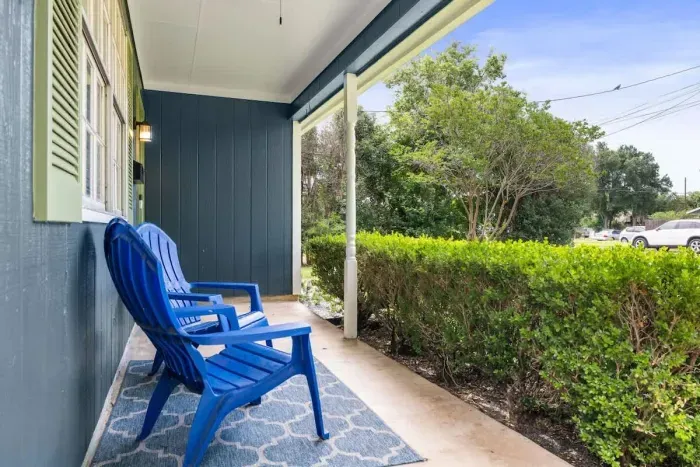 Relax in the exterior front, featuring a cozy seating area that invites you to unwind and enjoy the surroundings. Whether it's morning coffee or a quiet evening, this charming spot offers a welcoming atmosphere right at your doorstep.