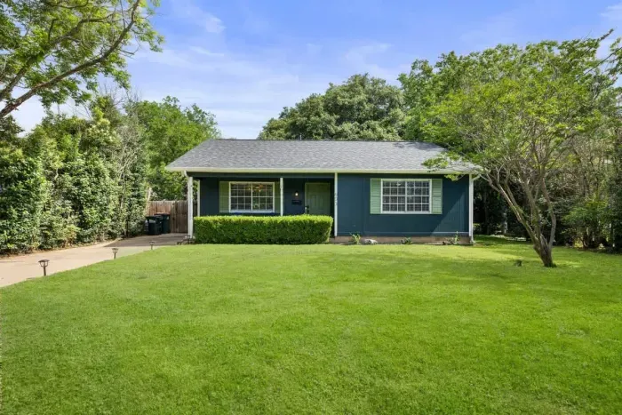 Spacious front yard with beautiful greenery and inviting entry